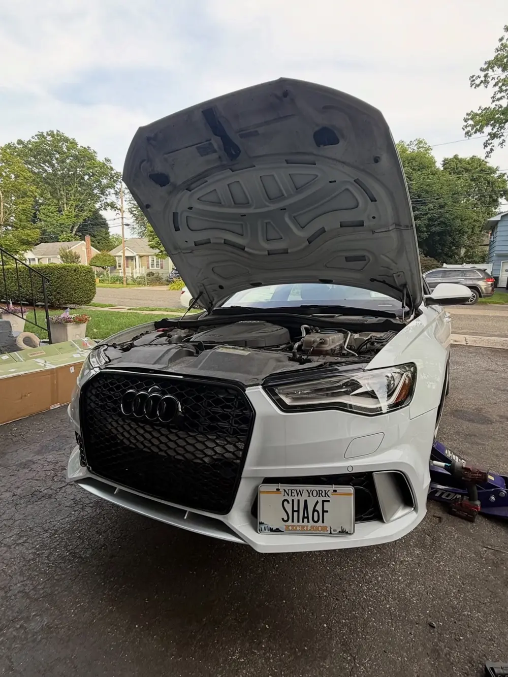 White Audi A6 with an RS-style honeycomb grille
