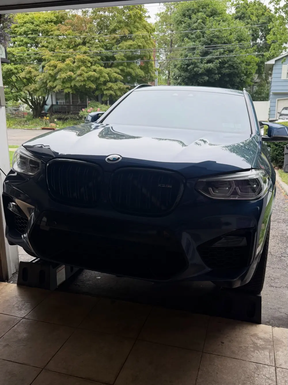 Blue BMW X3 M in the garage