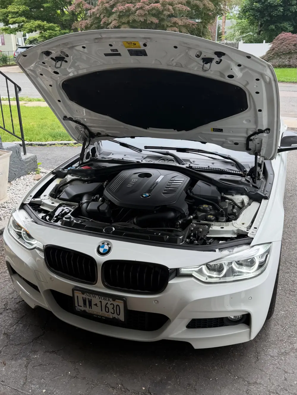 White 2018 BMW 340i with the hood open for a downpipe and evap system swap